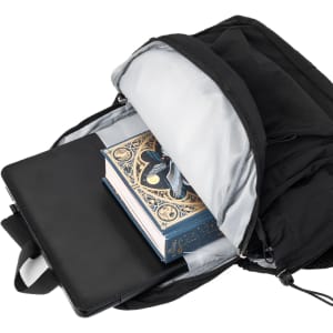A black backpack opened to reveal a book and a laptop inside, featuring a logo on the exterior.