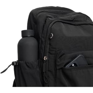A black Mono Backpack featuring a drink bottle in the side pocket and a phone visible in the front compartment.