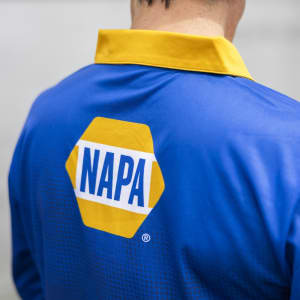 A men's long sleeve fishing polo in blue with a yellow collar and a logo on the back.