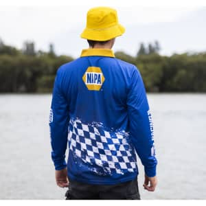 A blue long sleeve polyester fishing polo featuring a checkered pattern and a logo. A yellow bucket hat is worn.