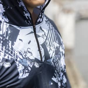 A men's polyester sublimated 1/4 zip fishing hoodie in dark blue with a graphic design and a logo.