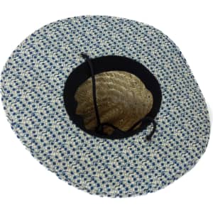 A straw hat with a patterned blue and white design and a black lining. It features a decorative inner shell pattern.