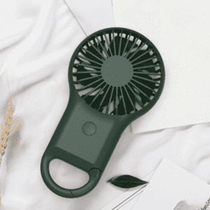 A portable pocket fan in dark green with a handle, featuring a circular fan design.