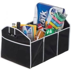 A black expandable boot organiser with multiple compartments, containing various bottles, cleaning products, and stationery.