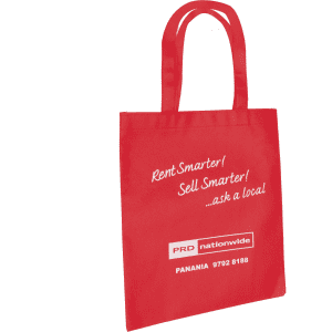 A red tote bag featuring sturdy handles and a branding logo. The bag has a simple, rectangular design.