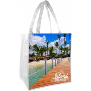 A tote bag featuring a vibrant tropical scene with palm trees and a wooden walkway, displayed against a white background.