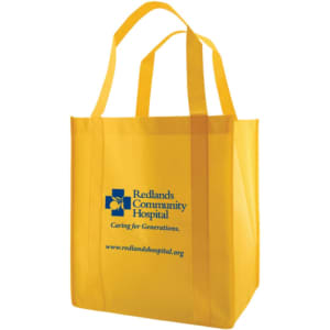 A large yellow reusable grocery bag with two handles and a logo on the front.