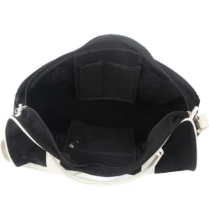 An open black and white duffle bag showcasing multiple interior pockets and compartments.