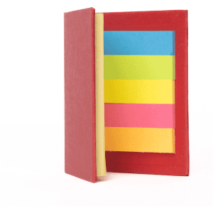 A red sticky note book with assorted sticky notes in yellow, green, blue, and pink inside.