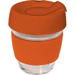 A glass coffee cup in clear with an orange silicon lid and band, designed for reusable drinkware.