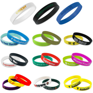 A collection of silicone wristbands in various colours, featuring different logos and text designs.