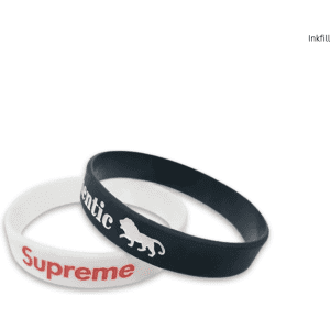 Two silicone wristbands, one black with a logo and one white with red text, displayed against a plain background.