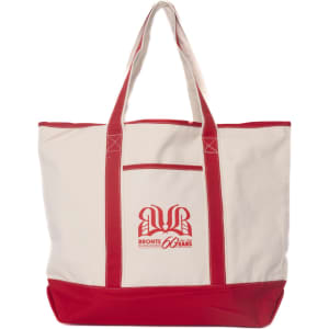 A cream canvas tote bag with red handles and a logo on the front.