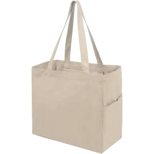 A natural-toned canvas tote bag with sturdy handles and a side pocket, featuring a logo.