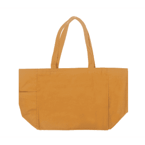 A mustard yellow canvas tote bag with two handles and a side pocket, featuring a logo.