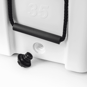 A cooler box in white with a black handle and drainage plug, featuring a small branding logo.