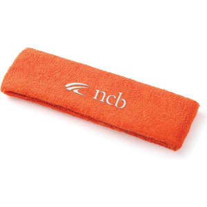 An orange plush terry sport headband with a logo on the front.