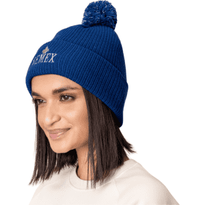 A blue Pom Pom Beanie Hat featuring a knitted design and a decorative pom pom on top, with branding present.