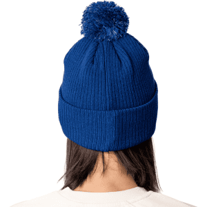 A blue Pom Pom Beanie Hat with a textured knitted design and a fluffy pom pom on top. Features branding on the hat.