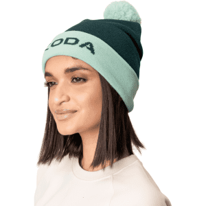 A teal and mint Pom Pom Beanie Hat with a fluffy pom pom at the top, featuring a logo.