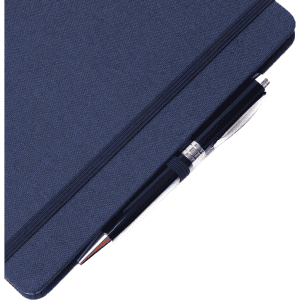 A fabric-covered A5 notebook in navy blue, featuring a silver pen resting on top.