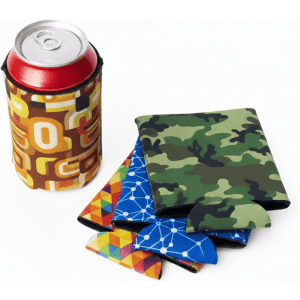 A drink can in a patterned stubby cooler accompanied by four brightly coloured coolers in various designs.