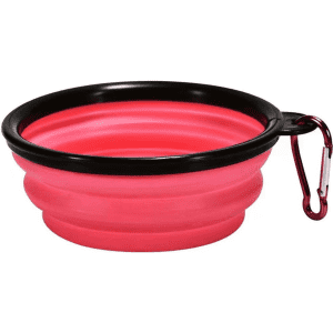 A pink silicone collapsible pet bowl with a black rim and a carabiner for easy attachment.