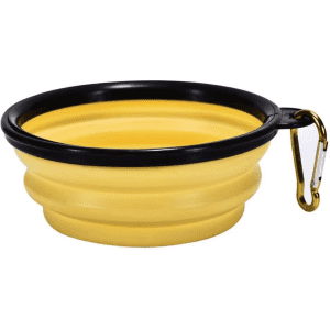 A collapsible pet bowl in yellow with a black rim, featuring a carabiner attachment for easy carrying.