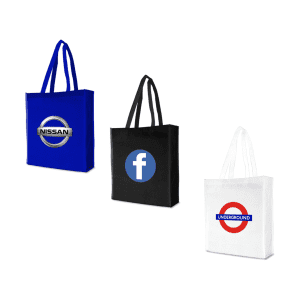 Three tote bags in blue, black, and white featuring logos, each with two handles.
