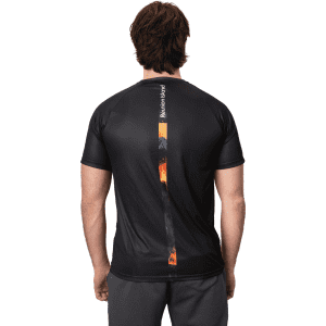 A black sublimated crafted tee featuring a flame design down the centre back, with a logo on the side.