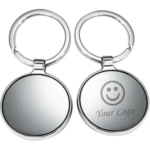 A silver keyring with a round design featuring a circular mirror surface and a logo.
