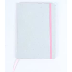A grey notebook with a pink elastic band and a ribbon bookmark, featuring a dotted texture on the cover.