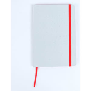 A grey notebook with a dotted pattern, featuring a red elastic band and bookmark. It has a simple design and no visible branding.