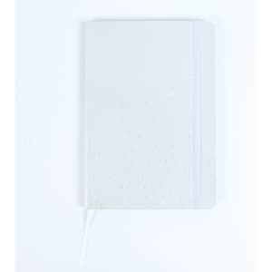 A white notebook with a dotted pattern, featuring a ribbon bookmark and an elastic band closure.