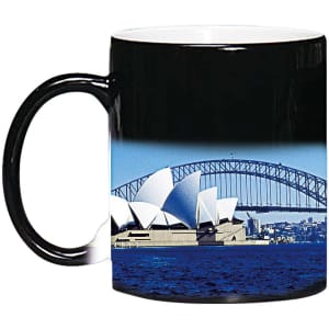 A coffee mug featuring a black exterior and an image of the Sydney Opera House and Harbour Bridge.