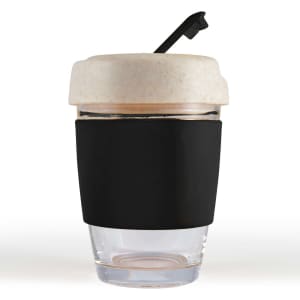 A reusable coffee cup featuring a transparent body, a beige lid with a straw, and a black silicone band for grip.