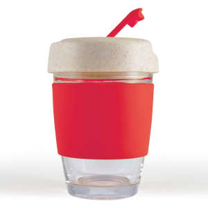 A reusable coffee cup with a clear base, a white lid, and a red silicone band and straw.