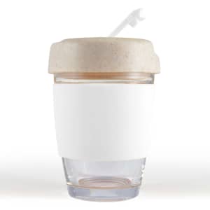 A reusable coffee cup featuring a clear glass base and a beige silicone band and lid. It has a straw.
