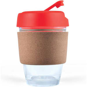 A reusable coffee cup featuring a clear body, a cork band for grip, and a red lid with a flip-top opening.