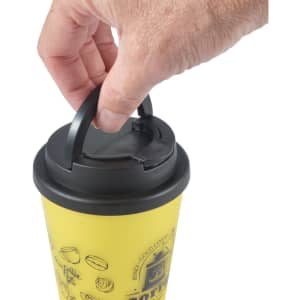 A yellow coffee mug with a black handle lid, featuring a hand gripping the lid.