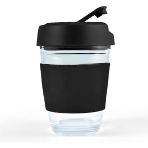 A reusable coffee cup with a transparent body and a black flip lid. The cup features a black silicone sleeve for grip.