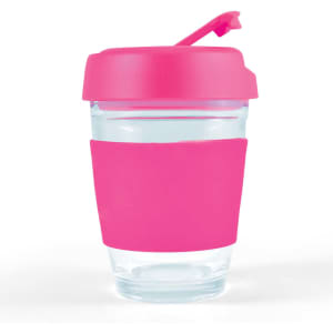 A reusable coffee cup with a clear body and a bright pink silicone sleeve and flip lid.