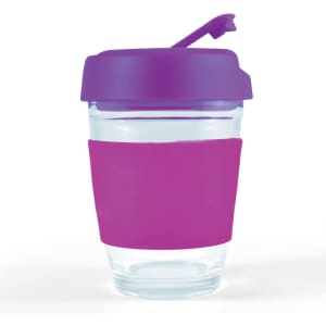 A reusable coffee cup with a clear body, purple flip lid, and a pink silicone sleeve for grip.