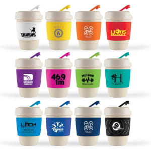 A collection of reusable coffee cups in various colours, each with a silicone band and a straw, featuring different logos.