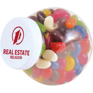 A clear container filled with assorted colour mini jelly beans, featuring various shades like red, green, yellow, and blue.