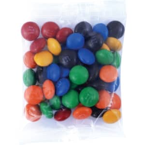 A clear bag filled with a variety of colorful M&M's, including red, blue, green, yellow, orange, and black candies.