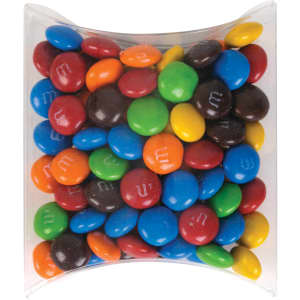 A pillow pack filled with colorful M&M's in various shades, including red, blue, green, yellow, brown, and orange.