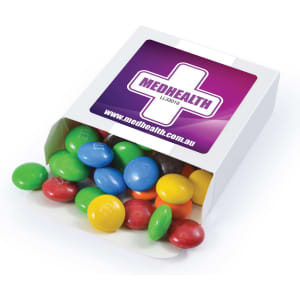 A box of M&M's containing colourful chocolate beans, including red, blue, green, yellow, and brown. The box has a logo.