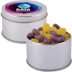 A silver round tin filled with colourful jelly beans in yellow and purple, featuring a branded lid.