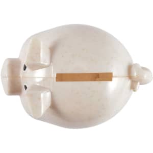 A small, eco-friendly pig-shaped coin bank with a light speckled finish and a slot for coins.